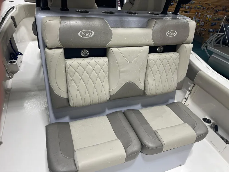 Slide: The Image of 2024 Key West 291FS boat interior with cushioned seating and cup holders. - 34