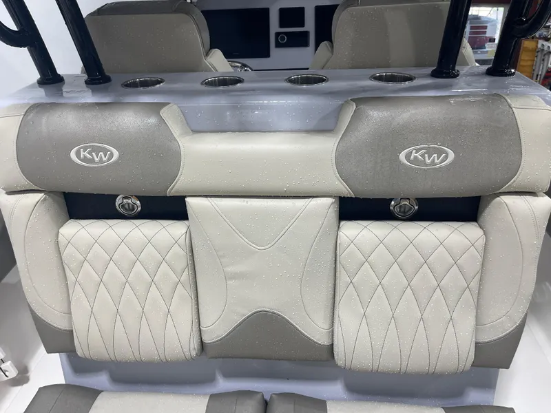 Slide: The Image of 2024 Key West 291FS boat interior with cushioned seating and cup holders. - 36