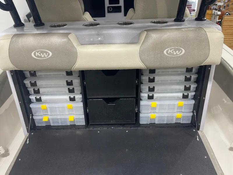 Slide: The Image of 2024 Key West 291FS boat storage with tackle boxes and rod holders. - 37