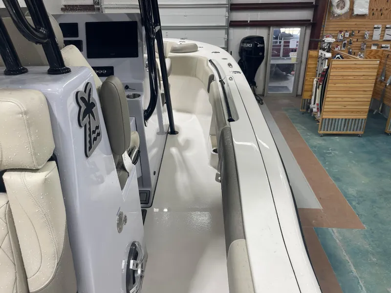 Slide: The Image of 2024 Key West 291FS boat interior with seating and control panel in showroom. - 39