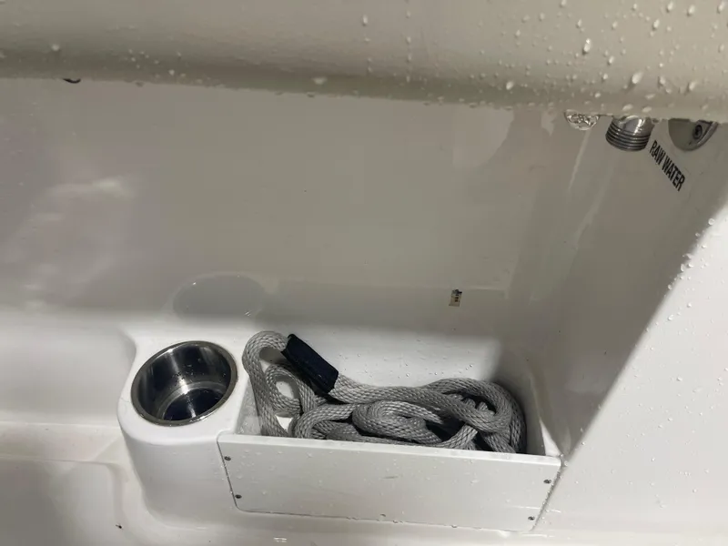Slide: The Image of 2024 Key West 291FS boat compartment with rope and cup holder. - 43