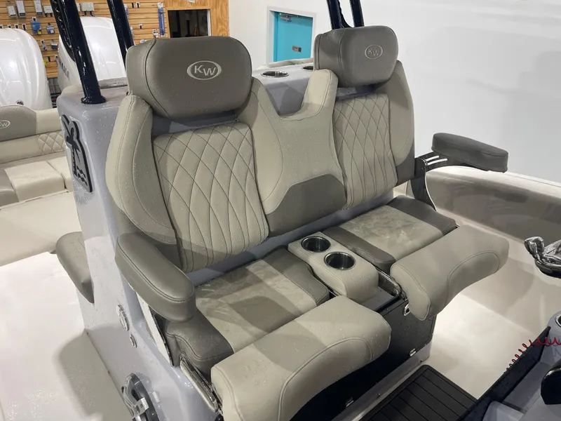Slide: The Image of 2024 Key West 291FS boat seats with cup holders and armrests in a showroom. - 46