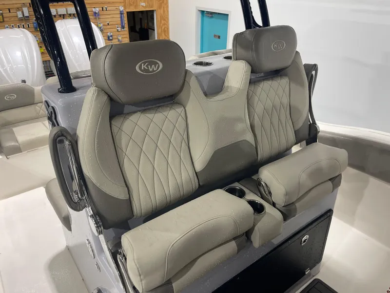 Slide: The Image of 2024 Key West 291FS boat interior with dual cushioned seats and cup holders. - 47