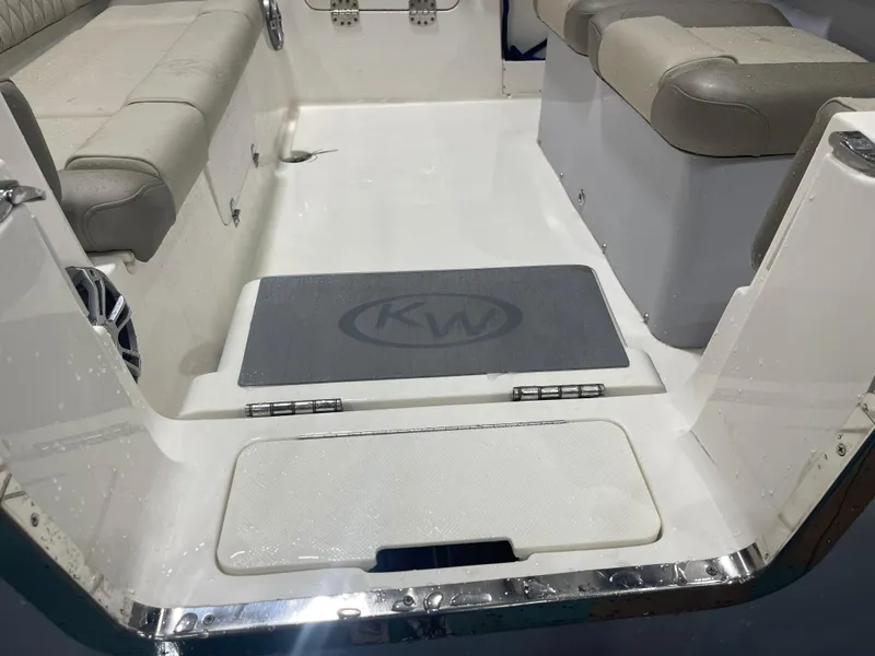 Slide: The Image of 2024 Key West 291FS boat interior with cushioned seating and non-slip flooring. - 7