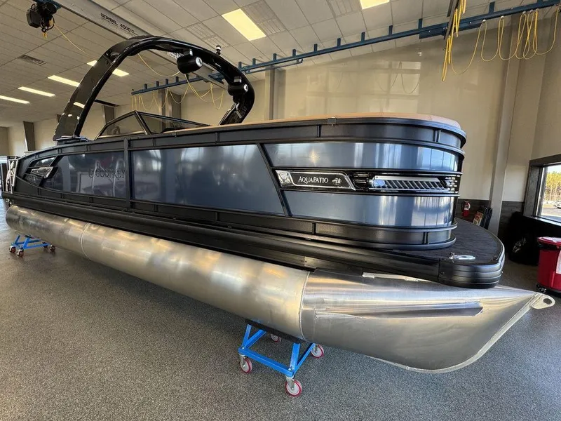 The Image of 2025 Godfrey AquaPatio 255 DFLW pontoon boat in showroom, sleek design, modern features. - 1