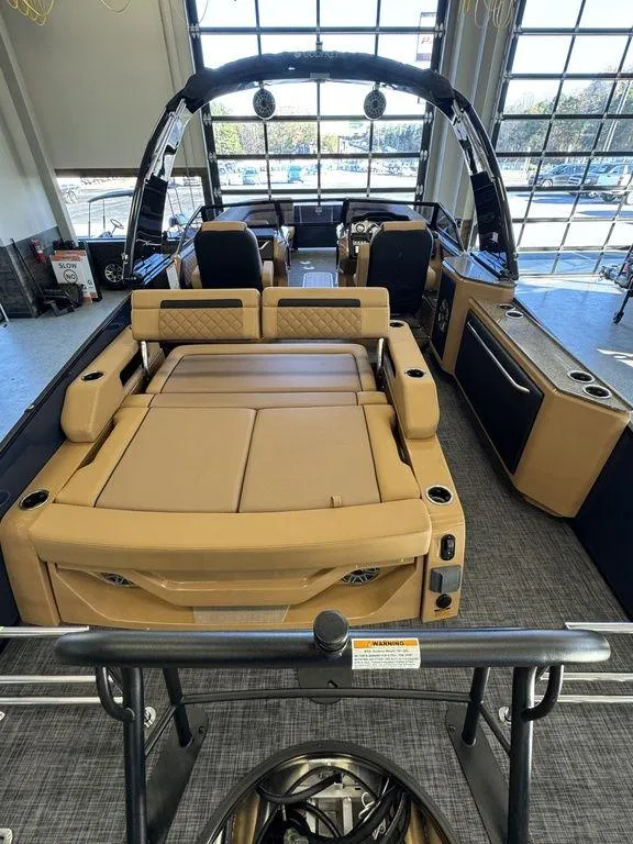 Slide: The Image of 2025 Godfrey AquaPatio 255 DFLW luxury pontoon boat interior with tan seating and modern design. - 11