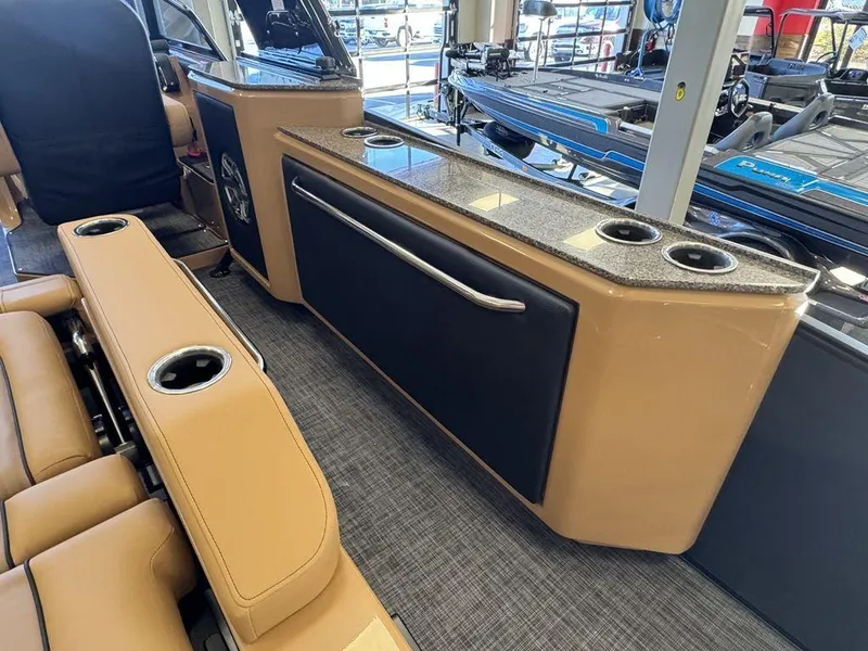 Slide: The Image of Interior of 2025 Godfrey AquaPatio 255 DFLW with tan seating and cup holders. - 12