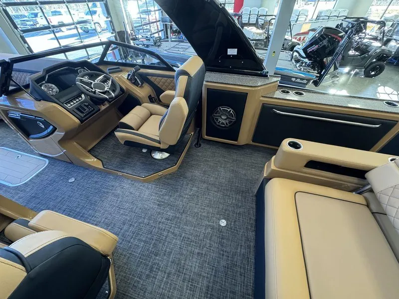 Slide: The Image of Interior of 2025 Godfrey AquaPatio 255 DFLW boat with luxurious seating and modern dashboard. - 18
