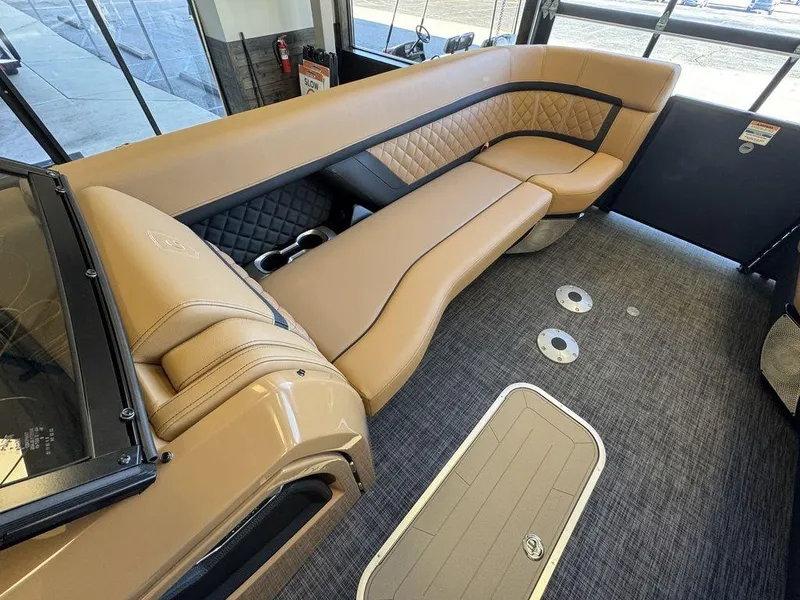 Slide: The Image of Luxurious interior of 2025 Godfrey AquaPatio 255 DFLW pontoon boat with tan seating. - 23