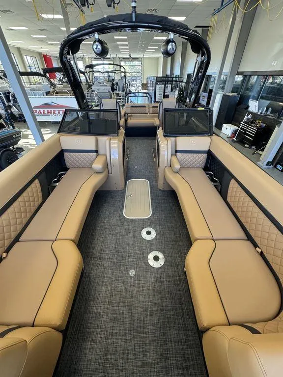 Slide: The Image of 2025 Godfrey AquaPatio 255 DFLW pontoon boat interior with tan seating and modern design. - 25