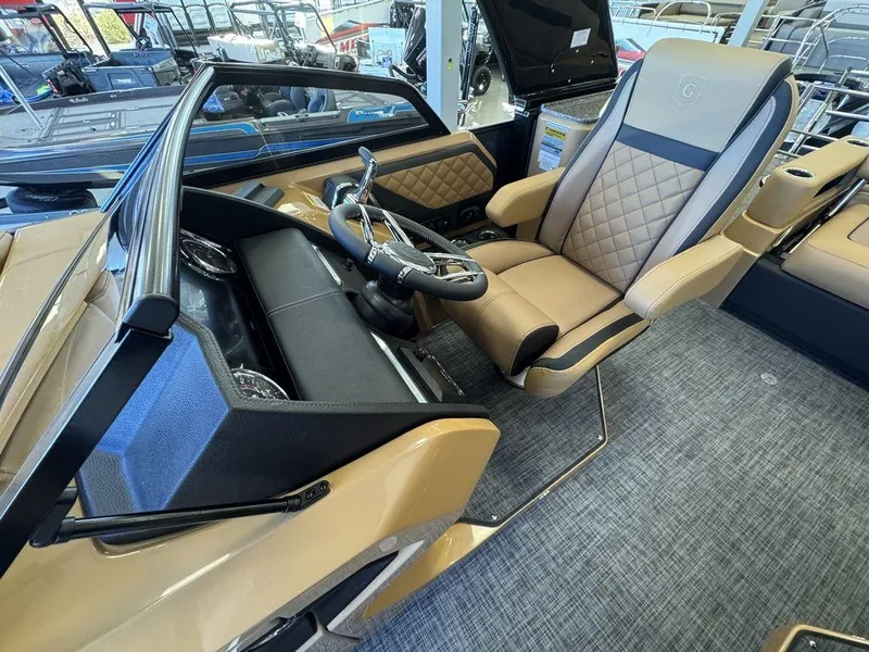 Slide: The Image of Luxurious interior of 2025 Godfrey AquaPatio 255 DFLW boat with plush seating and modern dashboard. - 28