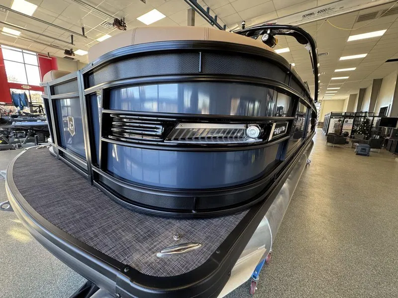 Slide: The Image of 2025 Godfrey AquaPatio 255 DFLW pontoon boat in showroom, sleek design and modern features. - 4