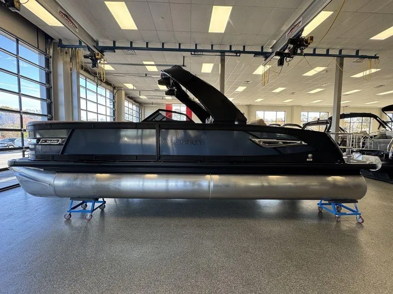 Slide: The Image of 2025 Godfrey AquaPatio 255 DFLW pontoon boat in showroom, side view. - 5
