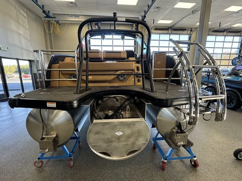 Slide: The Image of 2025 Godfrey AquaPatio 255 DFLW pontoon boat in showroom, rear view. - 7