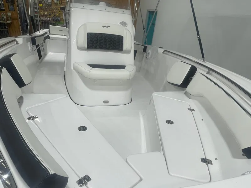 Slide: The Image of 2025 Tidewater 198CC boat interior with white seating and storage compartments. - 12