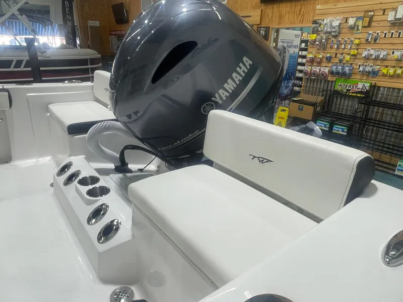 Slide: The Image of 2025 Tidewater 198CC boat interior with Yamaha engine, white seating, and cup holders. - 16