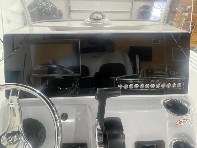 Slide: The Image of 2025 Tidewater 198CC boat dashboard with steering wheel and control panel. - 25