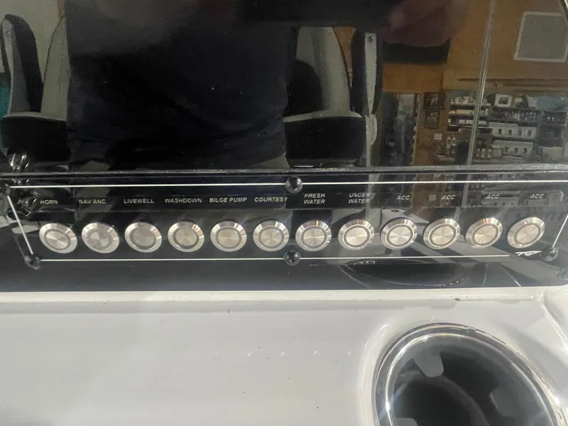 Slide: The Image of Control panel of 2025 Tidewater 198CC boat with various function buttons. - 27