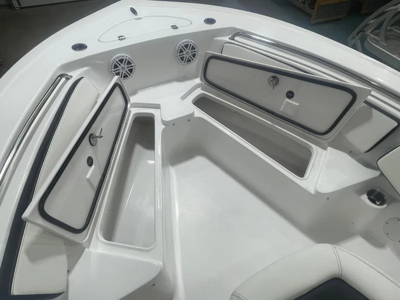 Slide: The Image of 2025 Tidewater 198CC boat interior with open storage compartments and speakers. - 31