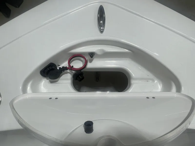 Slide: The Image of 2025 Tidewater 198CC boat storage compartment with open hatch and wiring. - 33