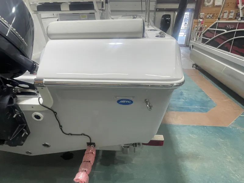 Slide: The Image of 2025 Tidewater 198CC boat in showroom, rear view with motor and seating. - 8