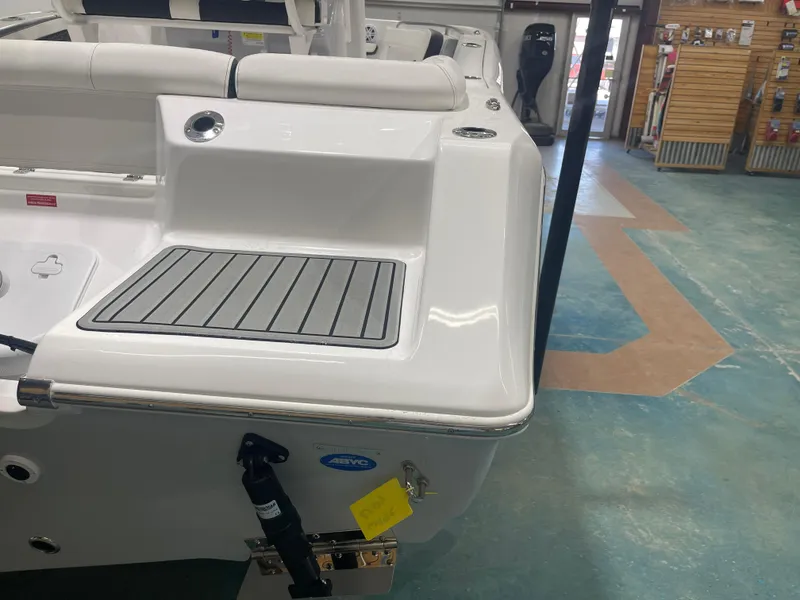 Slide: The Image of 2025 Tidewater 210LXF boat interior, featuring sleek seating and modern design in a showroom. - 10