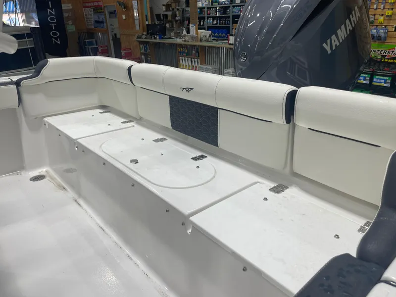 Slide: The Image of 2025 Tidewater 210LXF boat interior with Yamaha engine in showroom. - 12