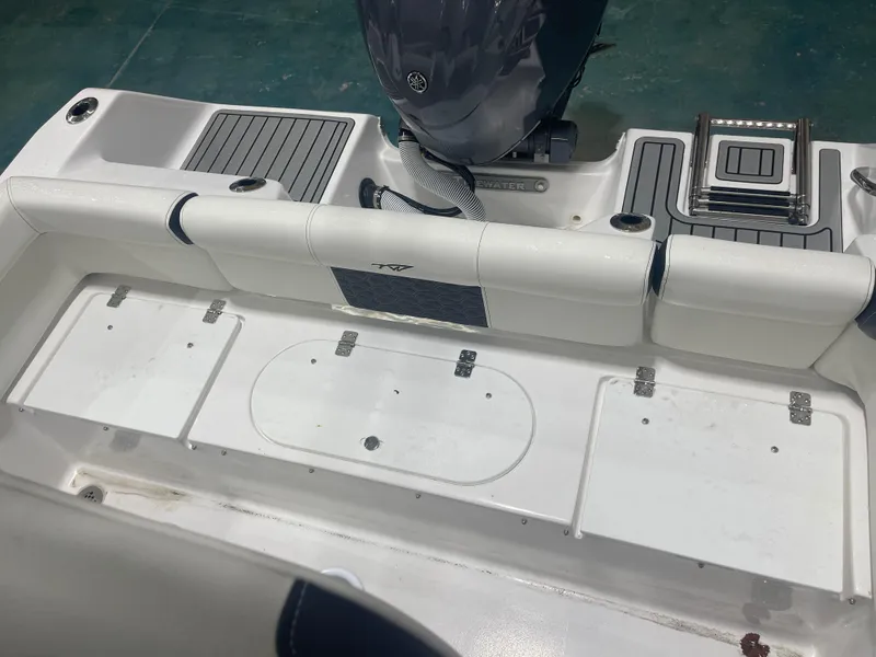 Slide: The Image of 2025 Tidewater 210LXF boat interior with seating and storage compartments. - 13