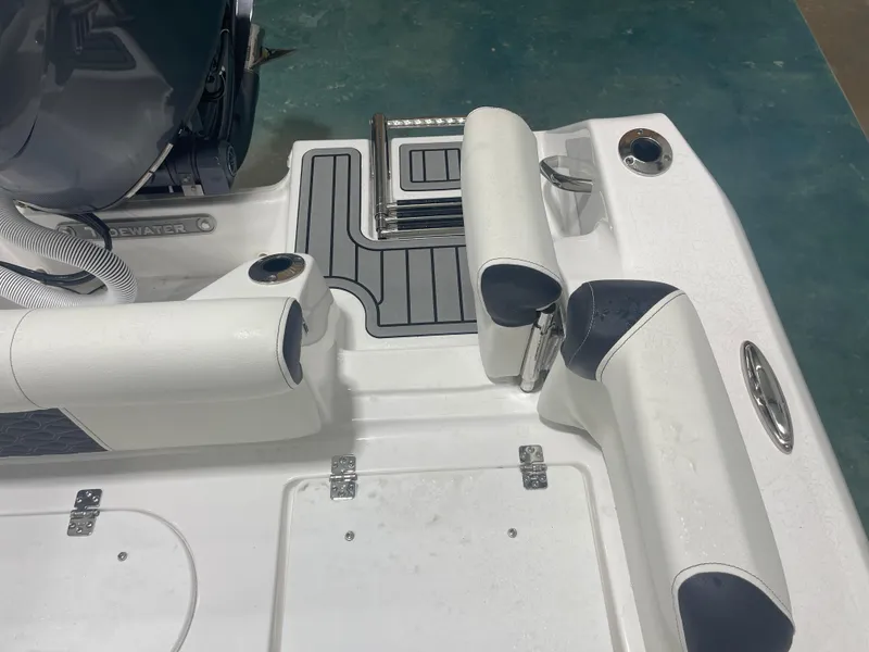 Slide: The Image of 2025 Tidewater 210LXF boat interior with cushioned seating and sleek design. - 14