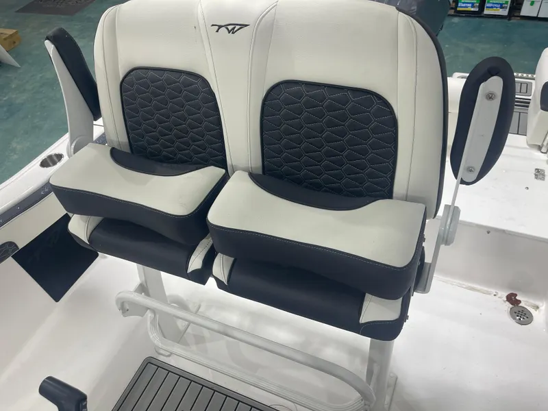 Slide: The Image of 2025 Tidewater 210LXF boat seats with black and white upholstery. - 16