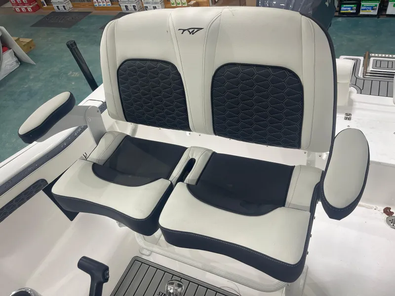 Slide: The Image of 2025 Tidewater 210LXF boat seating with black and white upholstery. - 17
