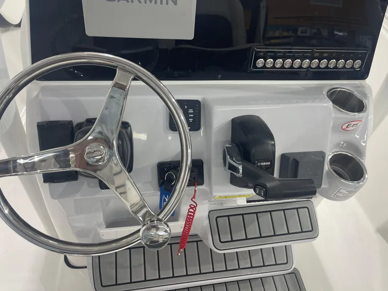 Slide: The Image of 2025 Tidewater 210LXF boat console with steering wheel and controls. - 19