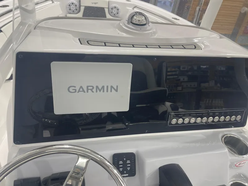 Slide: The Image of 2025 Tidewater 210LXF boat dashboard with Garmin navigation system and control panel. - 20