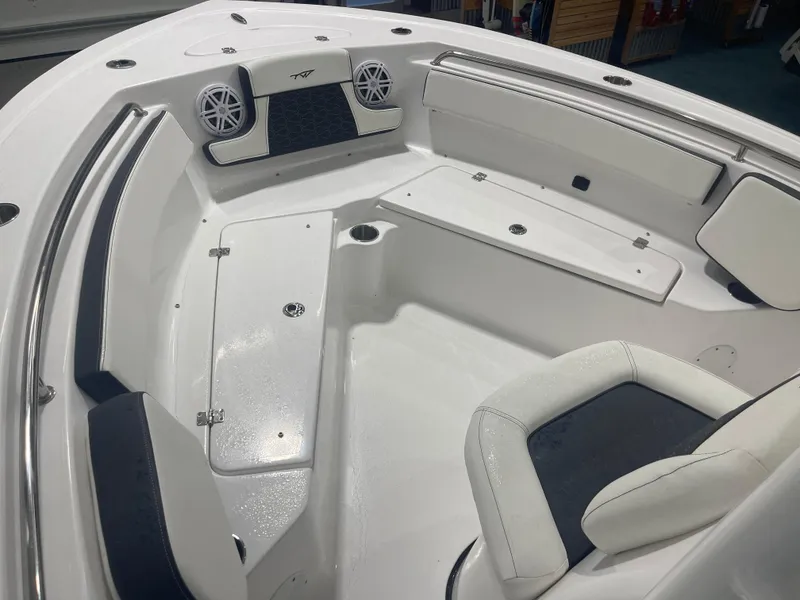 Slide: The Image of 2025 Tidewater 210LXF boat interior with white seating and speakers. - 23