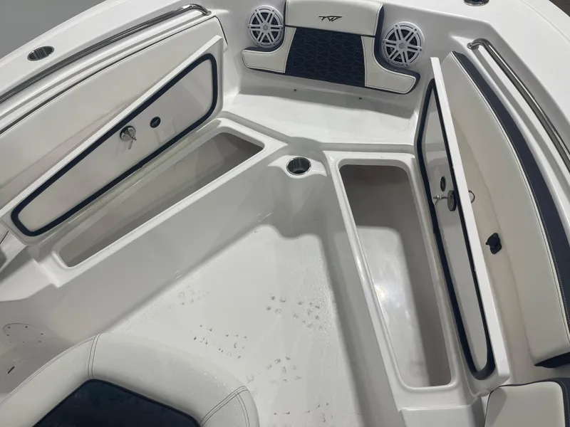 Slide: The Image of 2025 Tidewater 210LXF boat interior with storage compartments and speakers. - 24