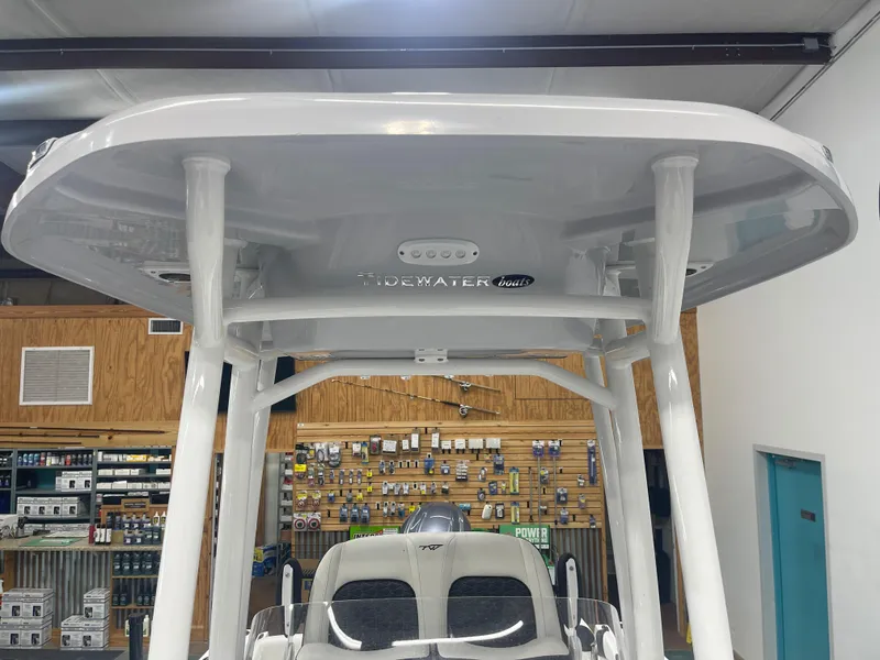 Slide: The Image of 2025 Tidewater 210LXF boat interior with T-top in showroom. - 28