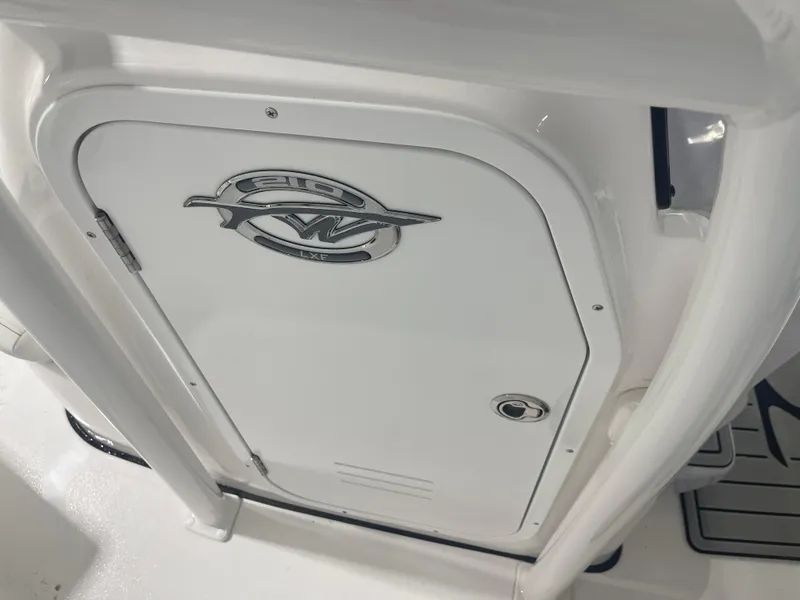 Slide: The Image of 2025 Tidewater 210LXF boat console with logo and storage compartment. - 31