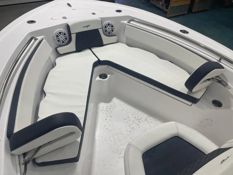 Slide: The Image of 2025 Tidewater 210LXF boat interior with cushioned seating and built-in speakers. - 33