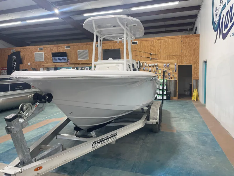 Slide: The Image of 2025 Tidewater 210LXF boat on trailer in showroom. - 6
