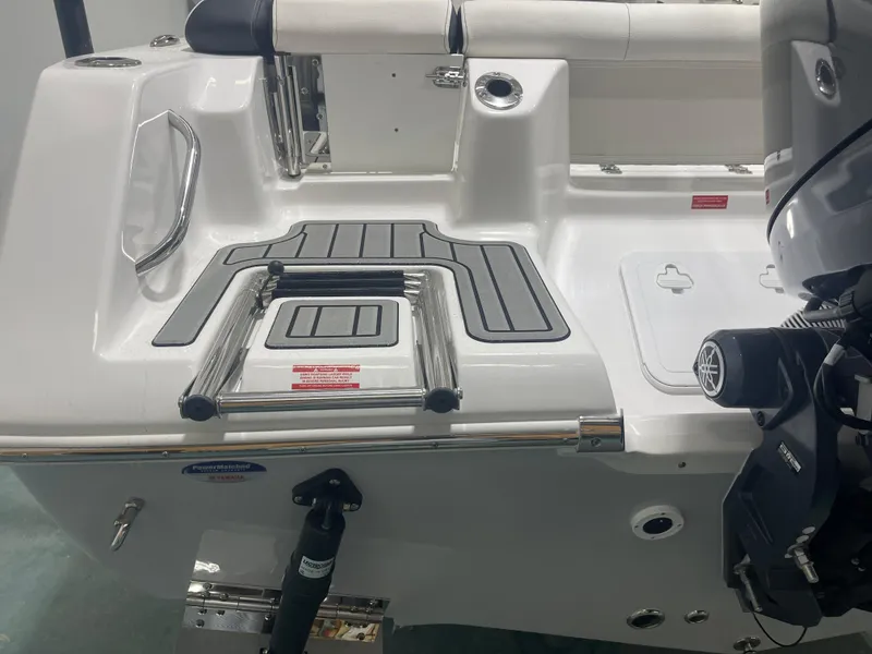 Slide: The Image of 2025 Tidewater 210LXF boat stern with swim platform and Yamaha outboard motor. - 9