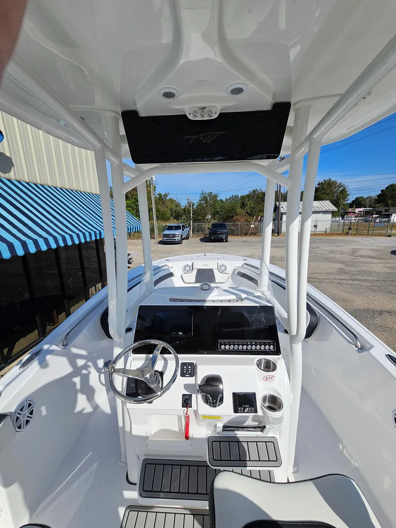 Slide: The Image of 2025 Tidewater 220LXF boat interior with steering console and modern controls. - 12