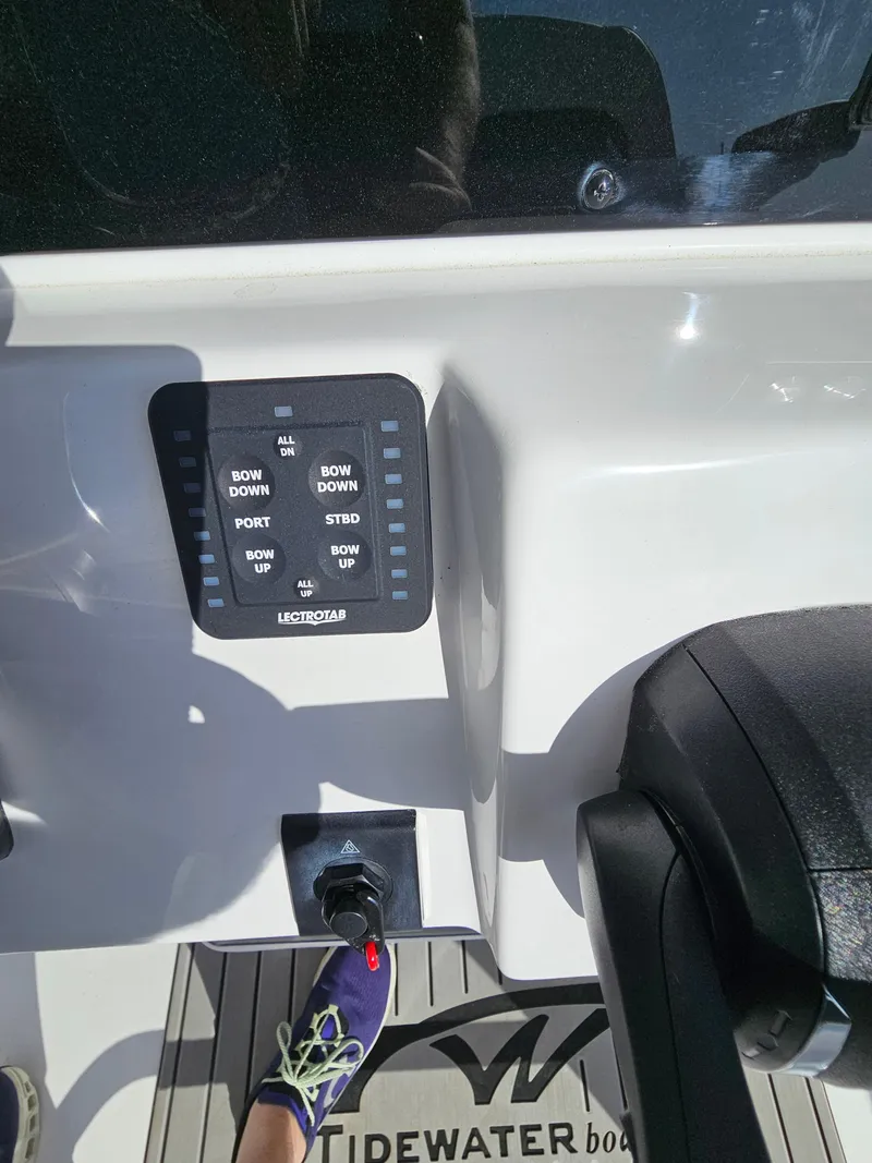 Slide: The Image of Control panel on 2025 Tidewater 220LXF boat with foot and throttle visible. - 14