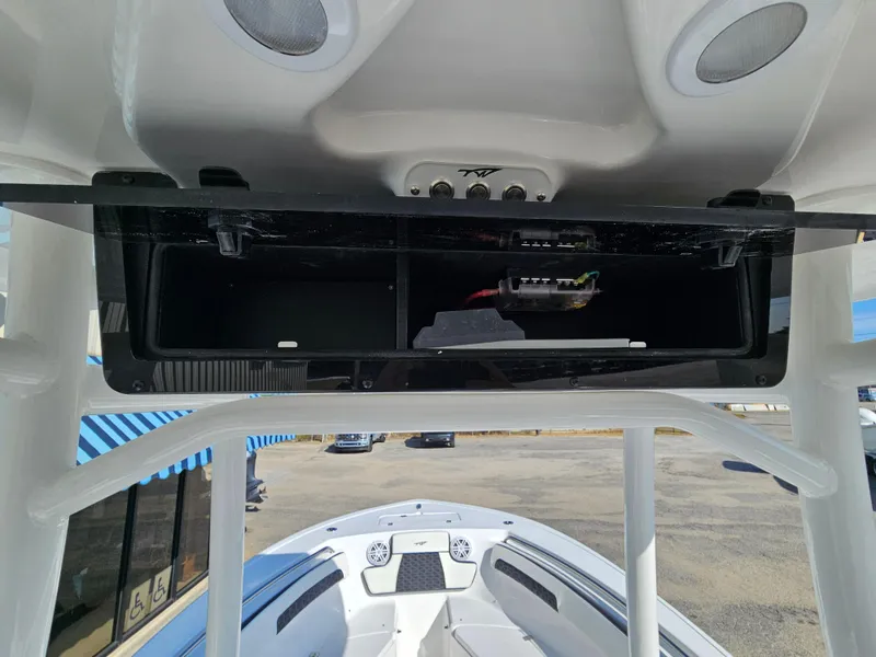 Slide: The Image of Tidewater 220LXF 2025 boat interior with open storage compartment and speakers. - 19