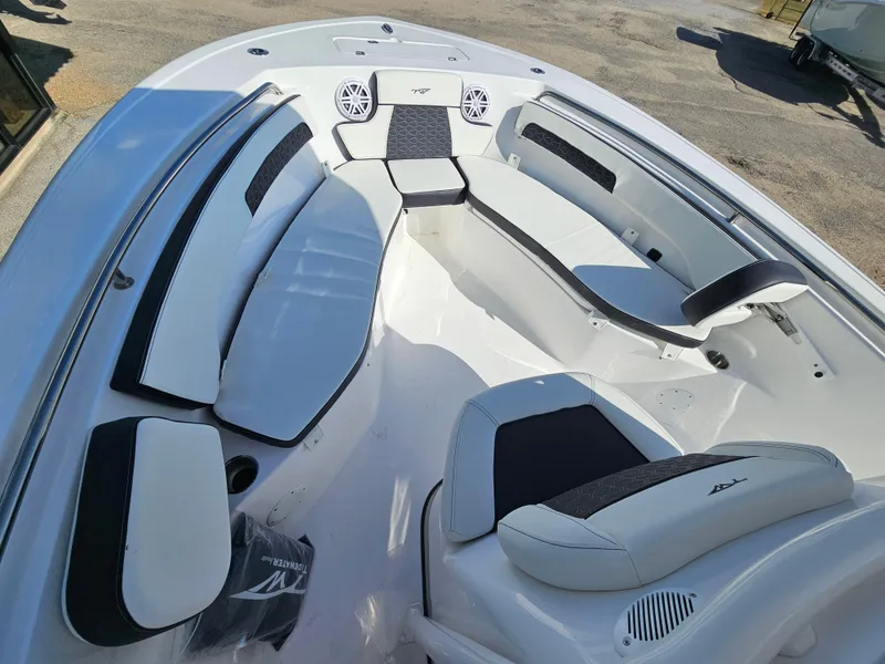 Slide: The Image of 2025 Tidewater 220LXF boat interior with cushioned seating and speakers. - 26