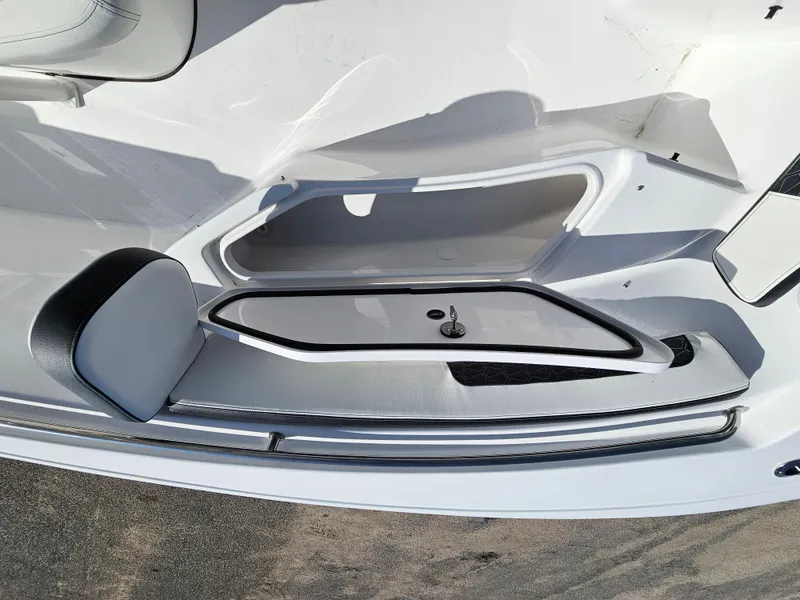 Slide: The Image of 2025 Tidewater 220LXF boat interior with storage compartment and seating. - 29