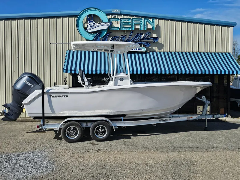 Slide: The Image of 2025 Tidewater 220LXF boat on trailer outside Ocean Marine building. - 3