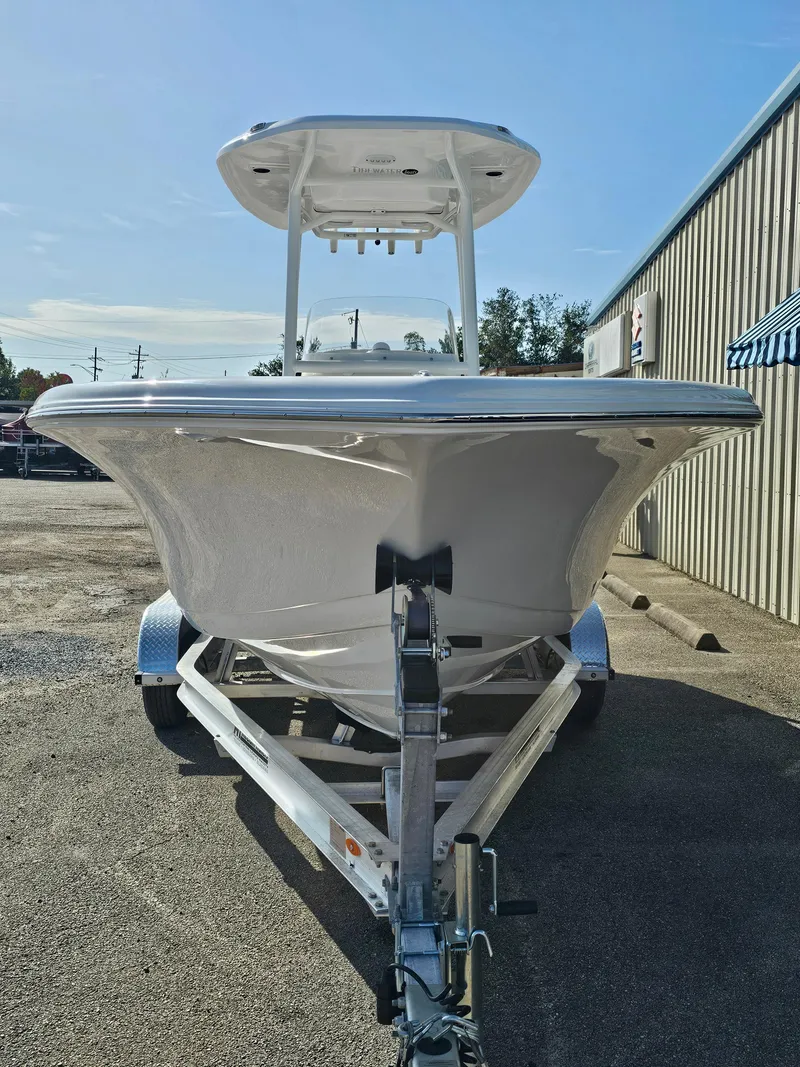 Slide: The Image of 2025 Tidewater 220LXF boat on trailer, parked outdoors, clear sky background. - 5