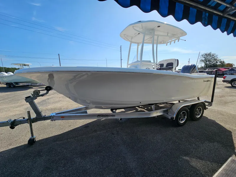 Slide: The Image of 2025 Tidewater 220LXF boat on trailer under blue sky. - 6