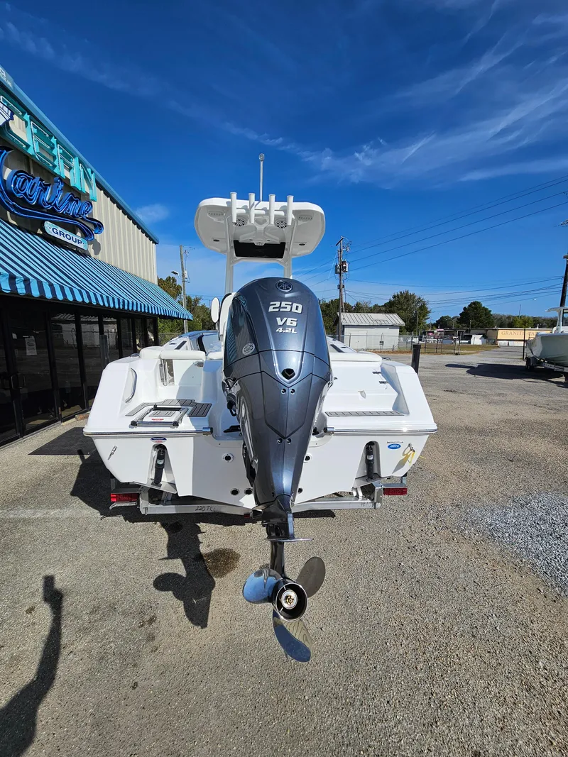 Slide: The Image of 2025 Tidewater 220LXF boat with 250 V6 engine, parked outdoors under clear sky. - 7