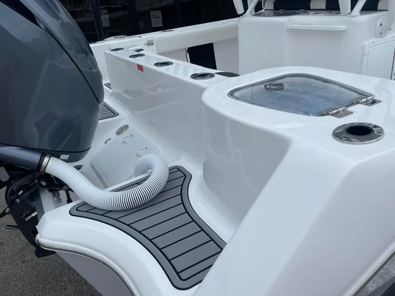 Slide: The Image of 2025 Tidewater 232cc boat deck with motor and storage compartments. - 10